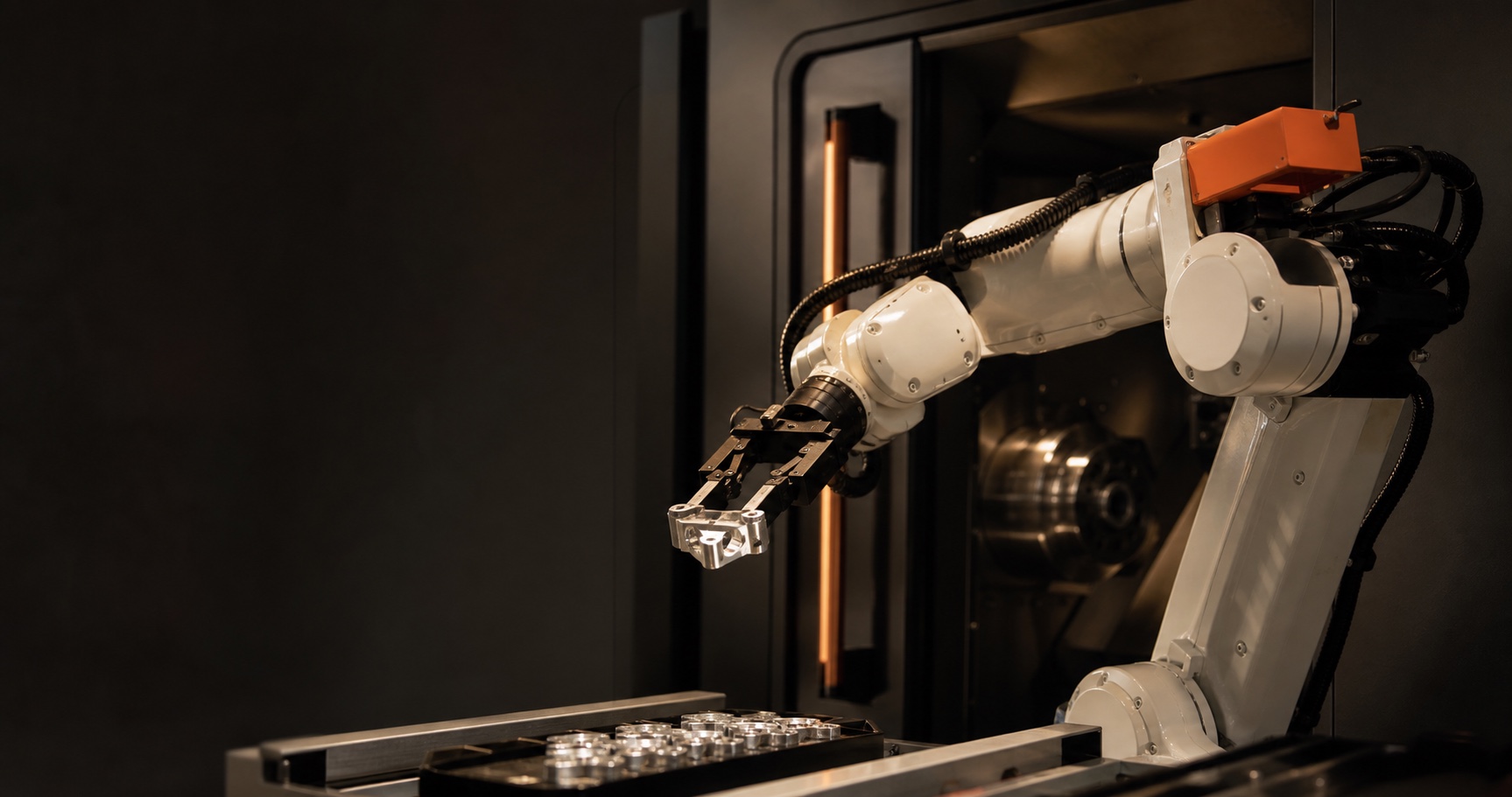 A robotic arm tending a CNC machine